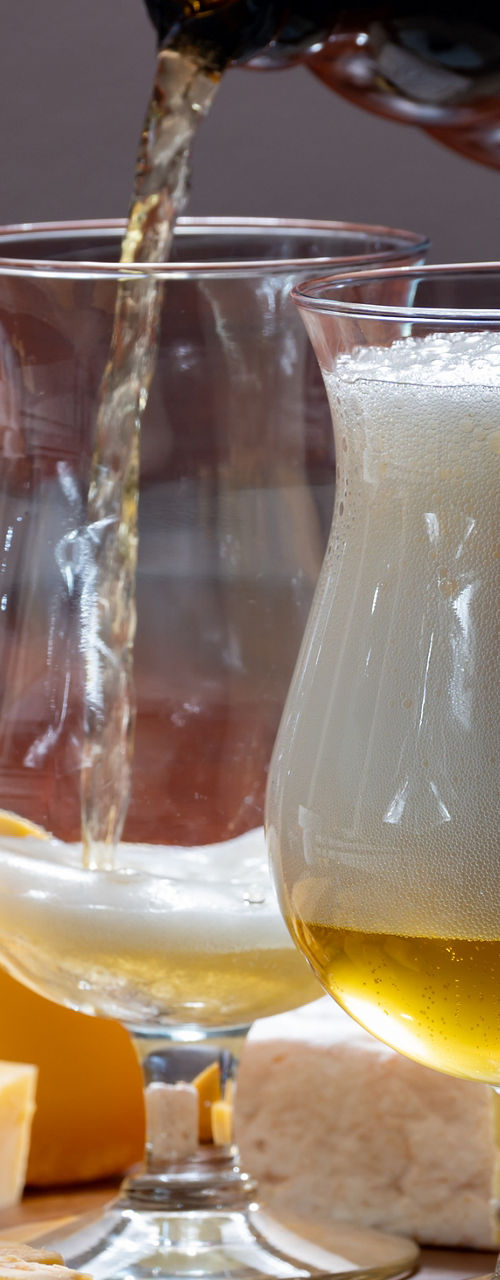 Craft beer poured with assorted cheeses