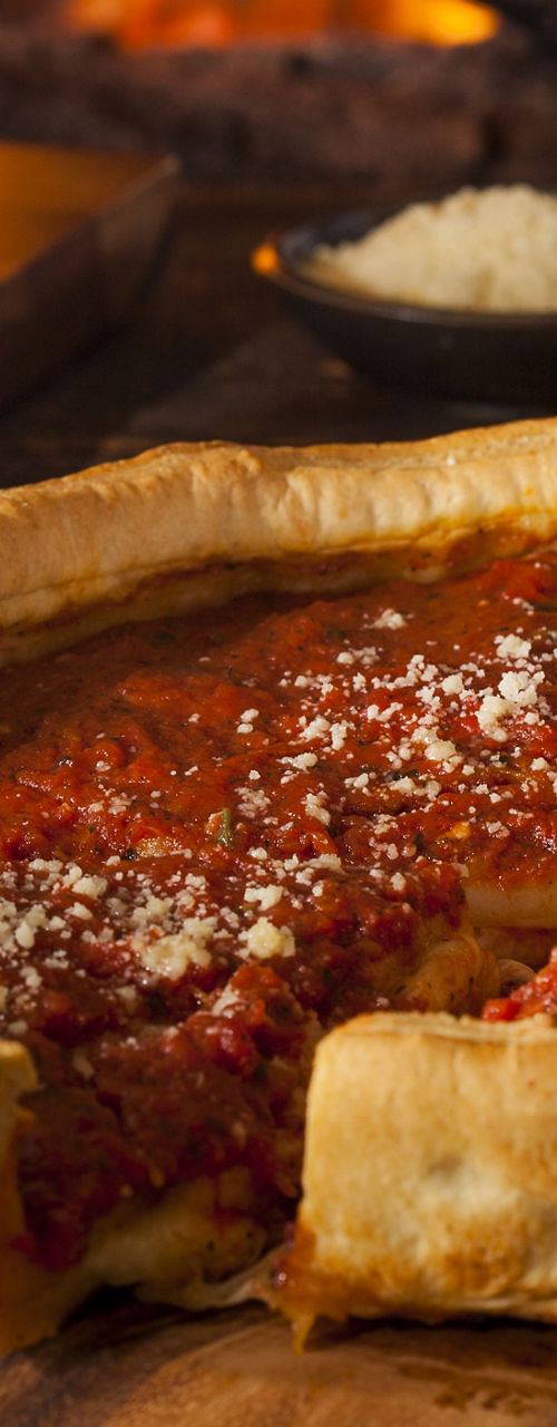 Deep dish pizza by a warm fireplace