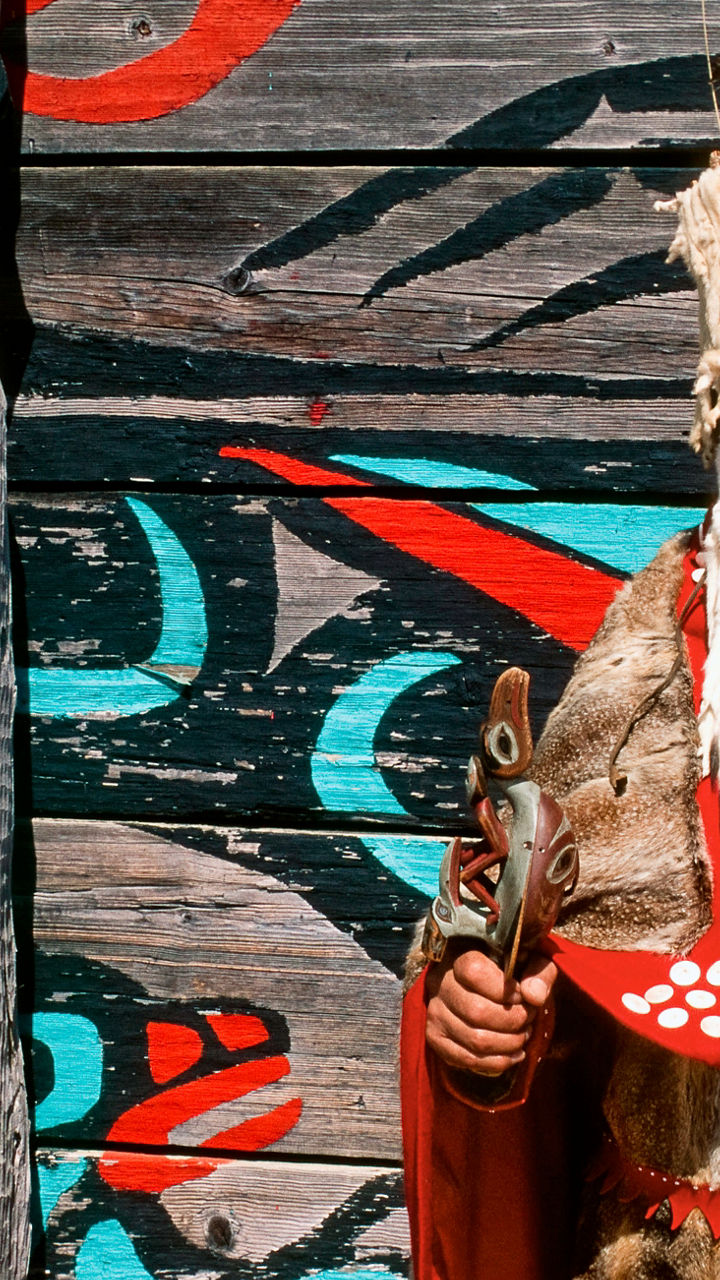 Traditional Indigenous attire with totem pole