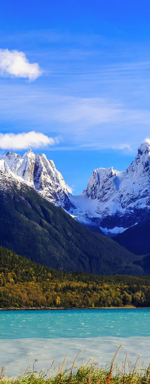 Snow-capped mountains with serene lake view