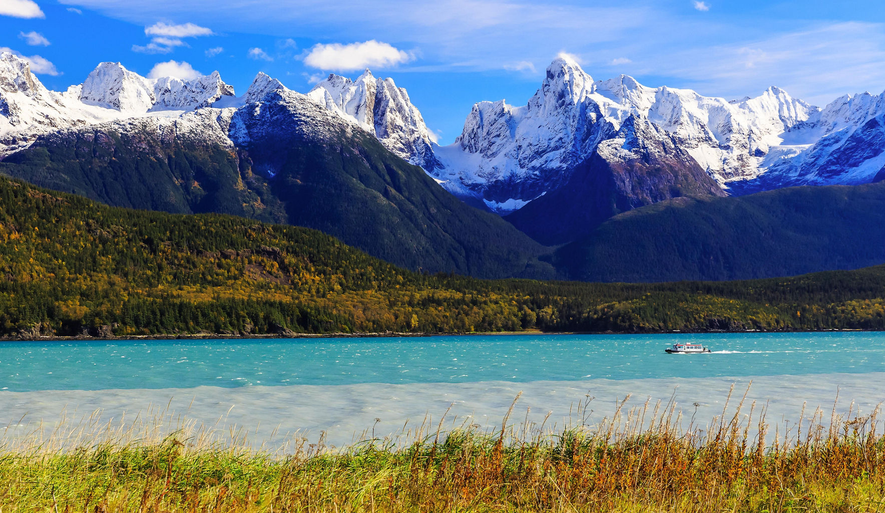 Snow-capped mountains with serene lake view
