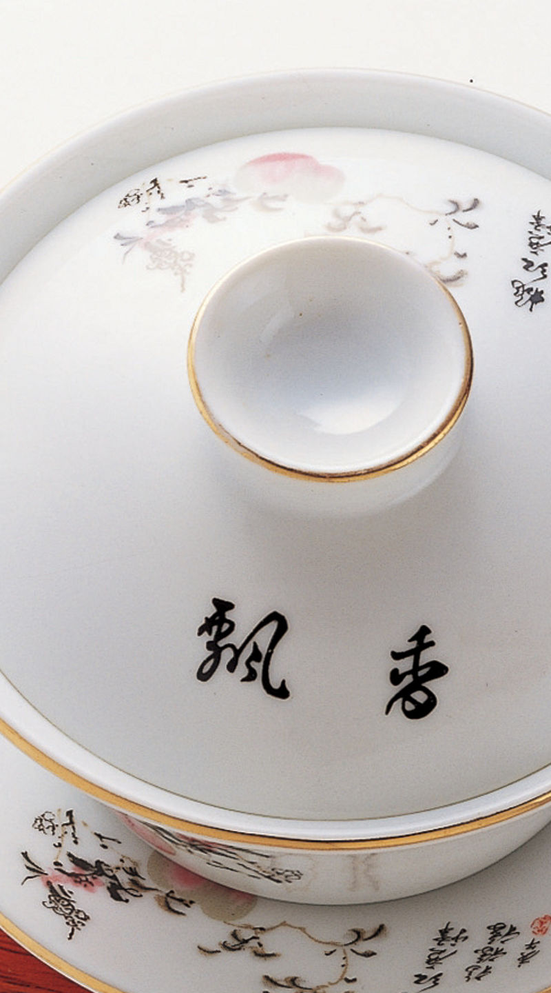 Elegant porcelain tea set on wooden stand