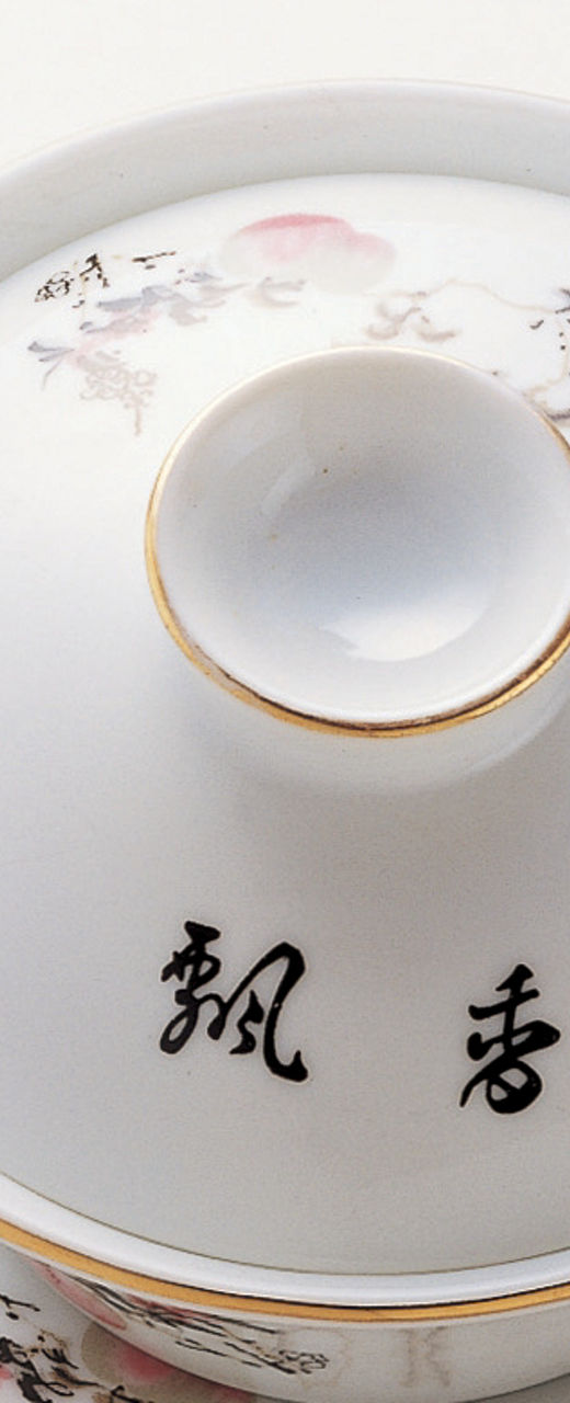 Elegant porcelain tea set on wooden stand