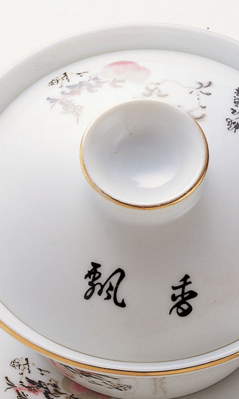 Elegant porcelain tea set on wooden stand