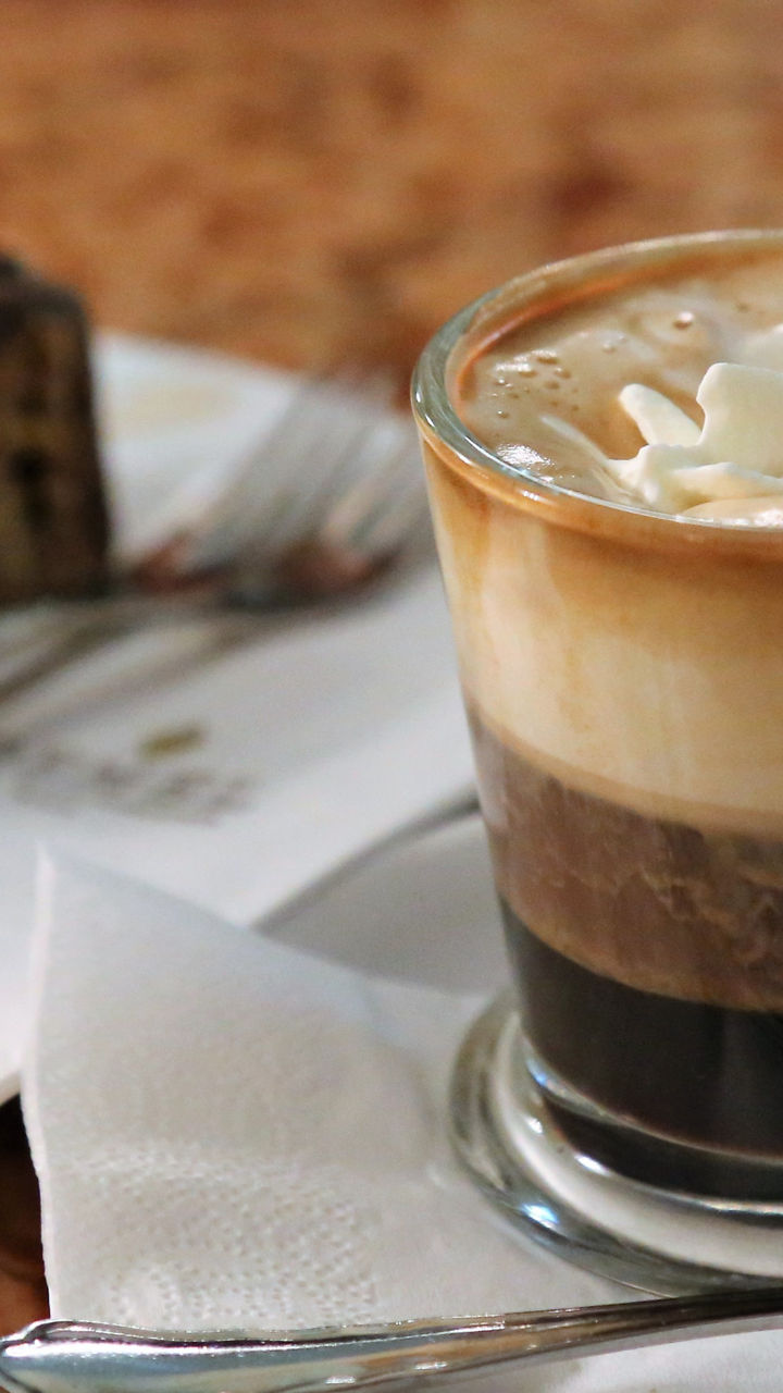 Coffee with whipped cream and cake slice