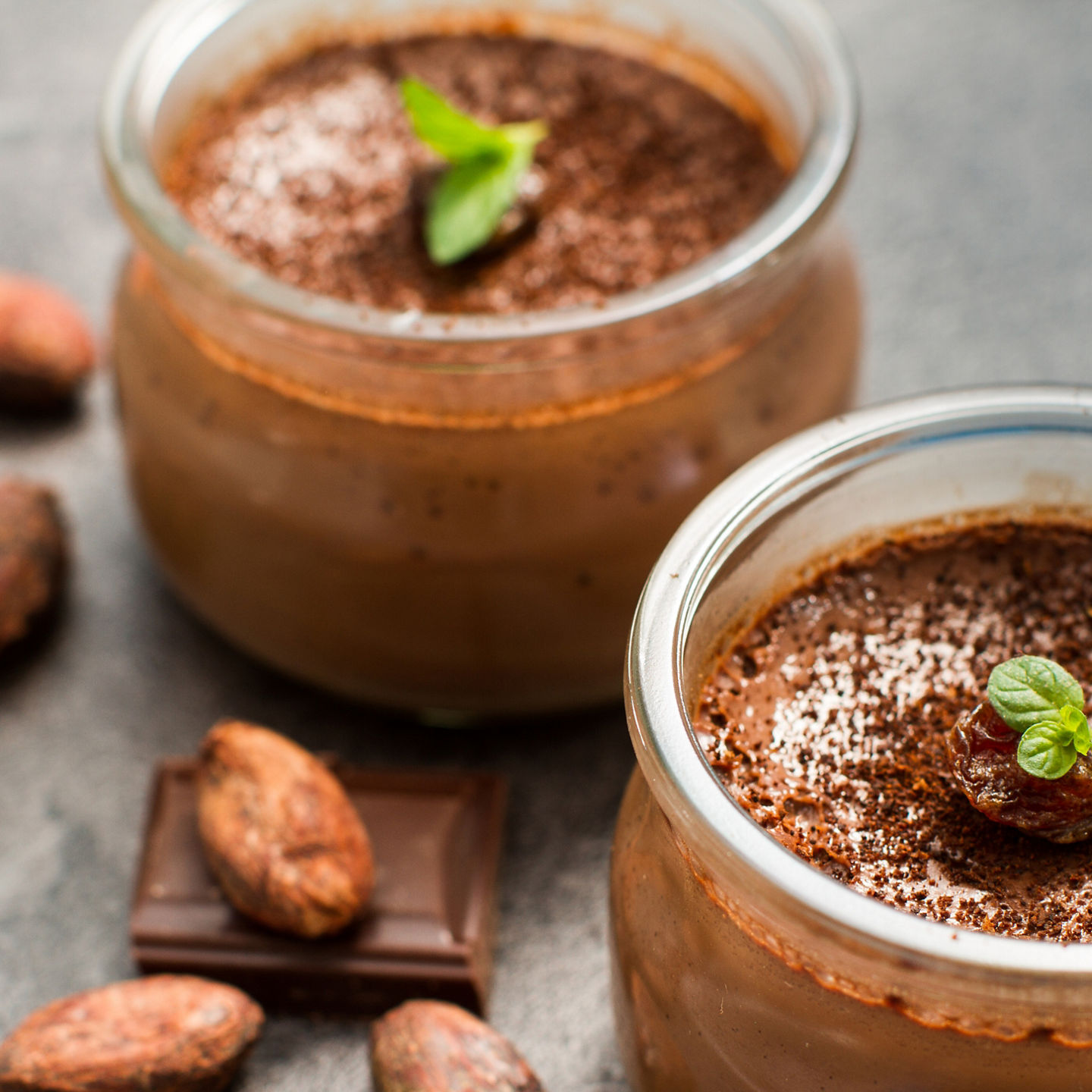 Chocolate mousse in glass jars with cocoa garnish