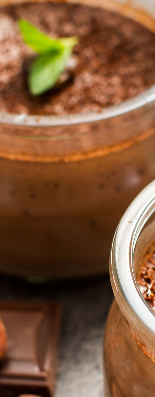 Chocolate mousse in glass jars with cocoa garnish