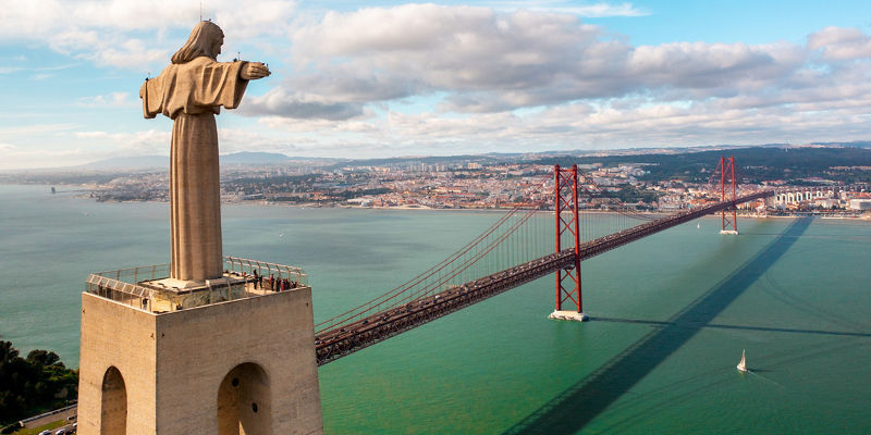 Christ the King statue overlooking Lisbon bridge