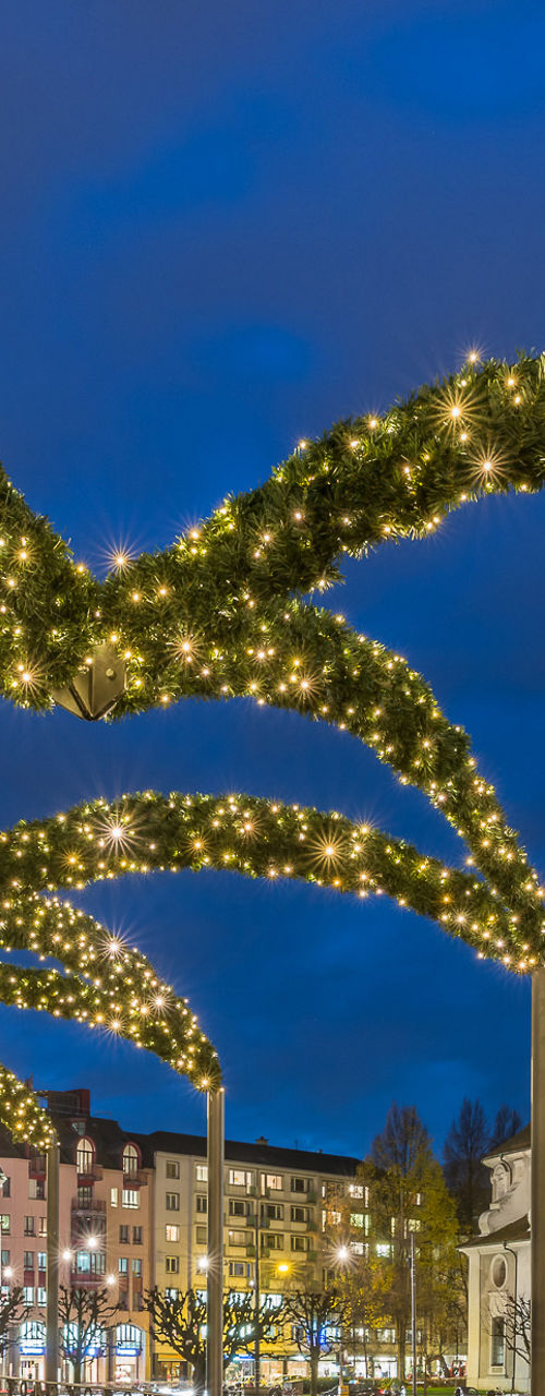 Illuminated bridge with festive arches at night