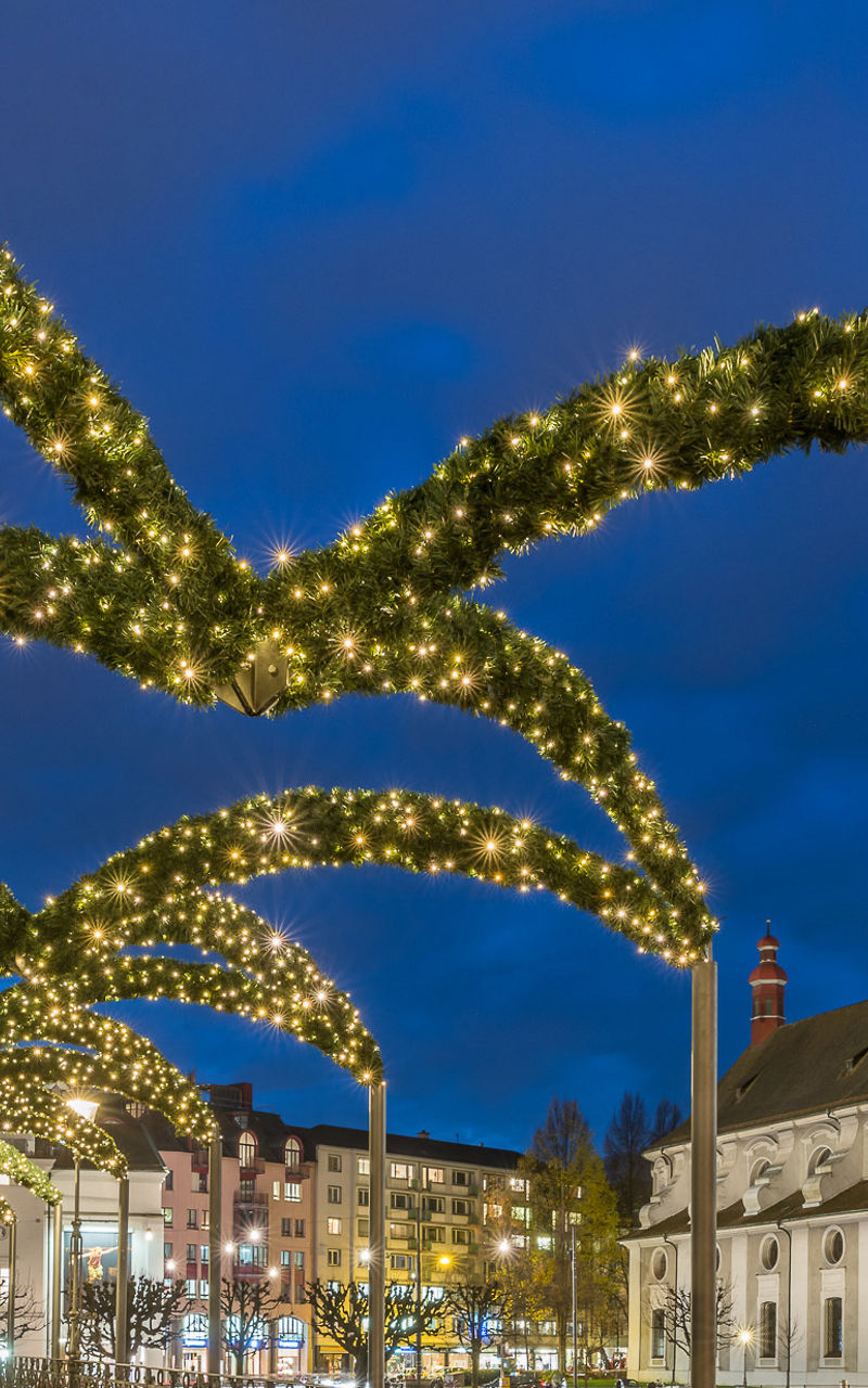 Illuminated bridge with festive arches at night