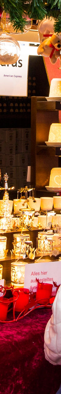Festive Christmas market stall with shoppers