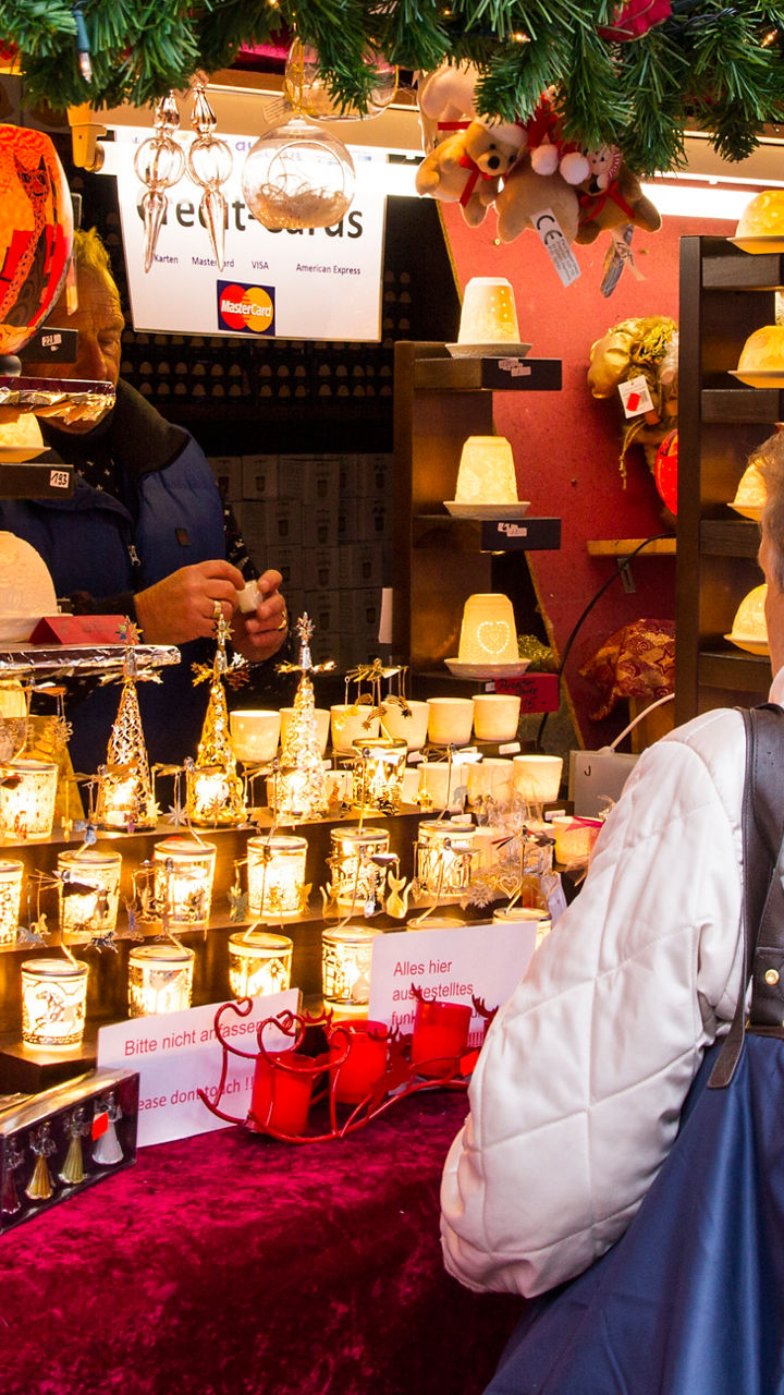 Festive Christmas market stall with shoppers