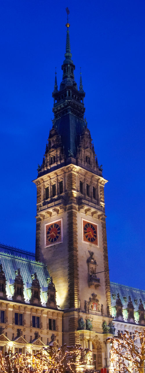 Illuminated Christmas tree near historic building