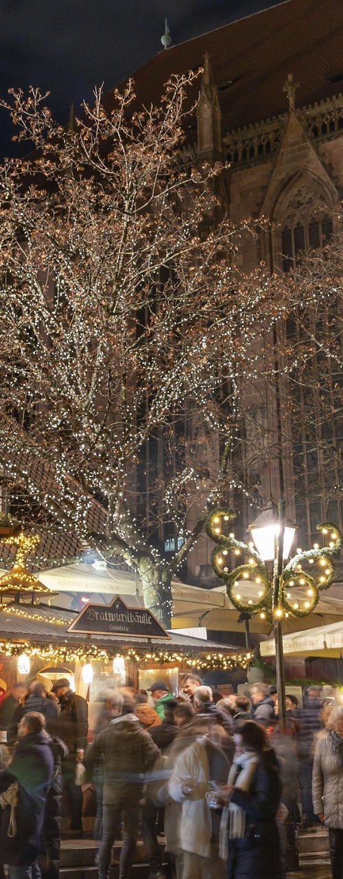 Nighttime Christmas market near Gothic cathedral