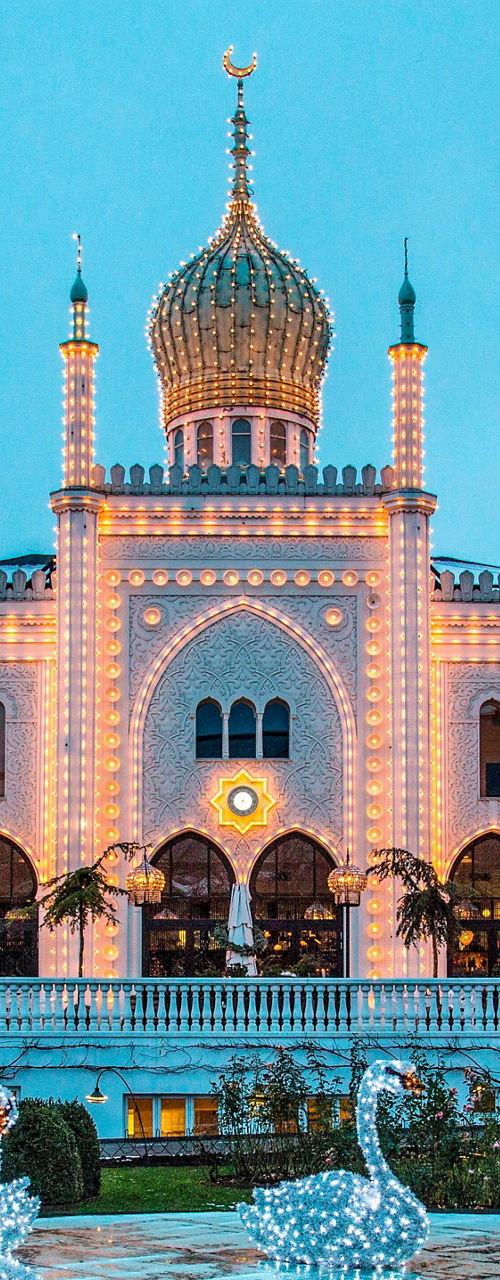 Illuminated palace with swan sculptures