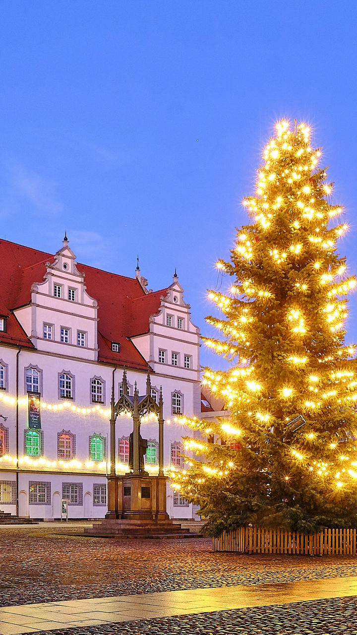 Historic town square with illuminated Christmas tree