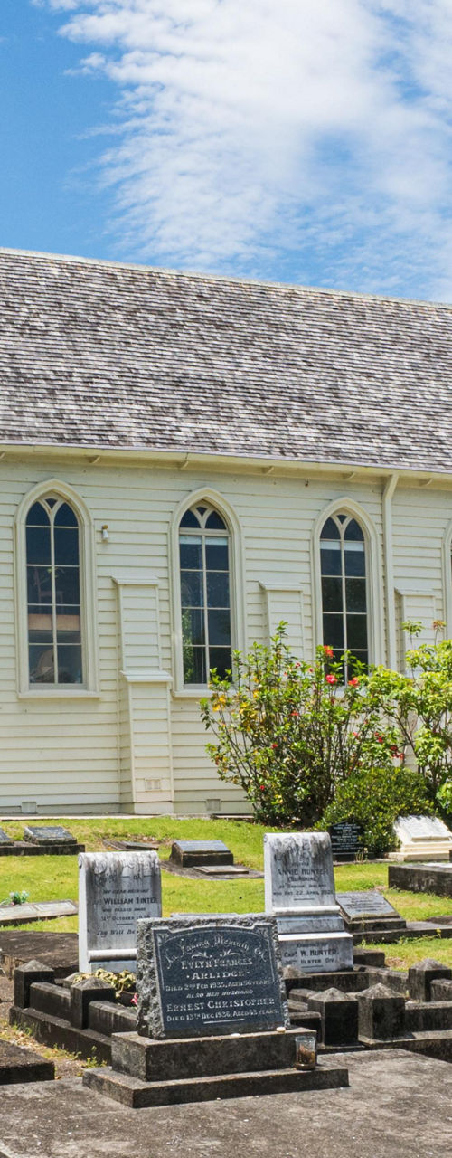 Historic church with cemetery under blue sky