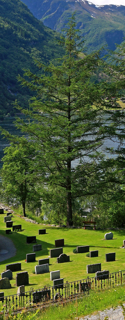 Scenic church by fjord with mountains