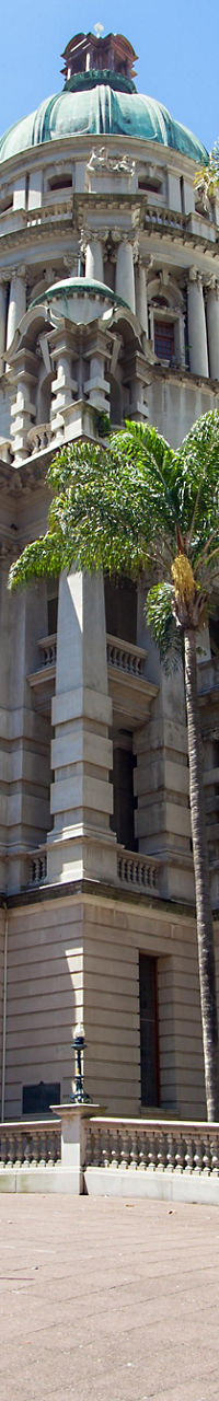 Historic building with palm trees in sunlight