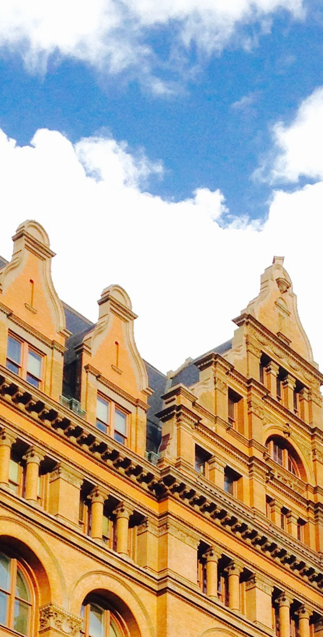 Historic building with clock tower under blue sky