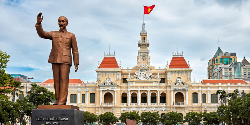 Ho Chi Minh statue with city hall backdrop