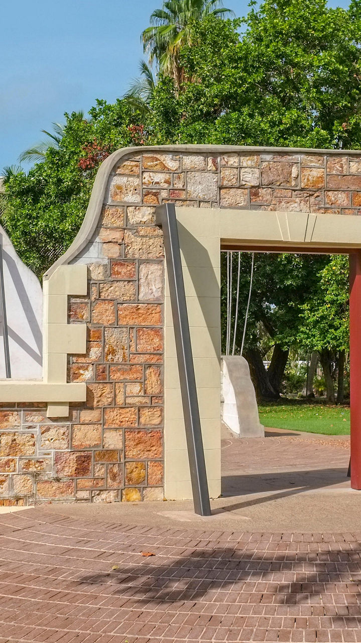 Historic stone archway in lush park setting