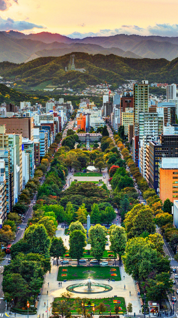 Urban park view with cityscape and mountains