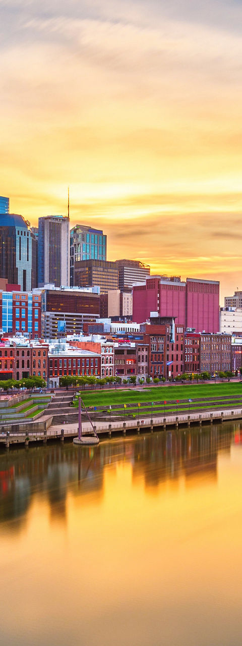 Nashville city skyline at sunset over river