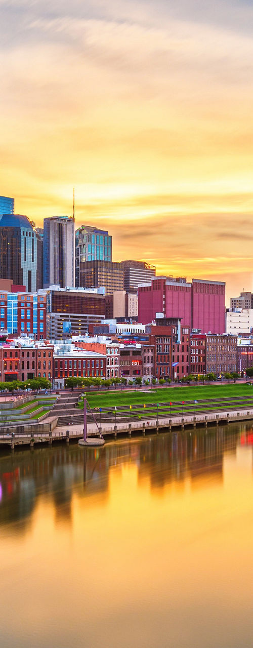 Nashville city skyline at sunset over river