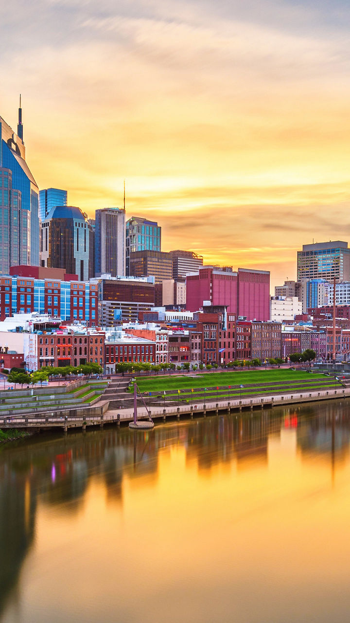 Nashville city skyline at sunset over river