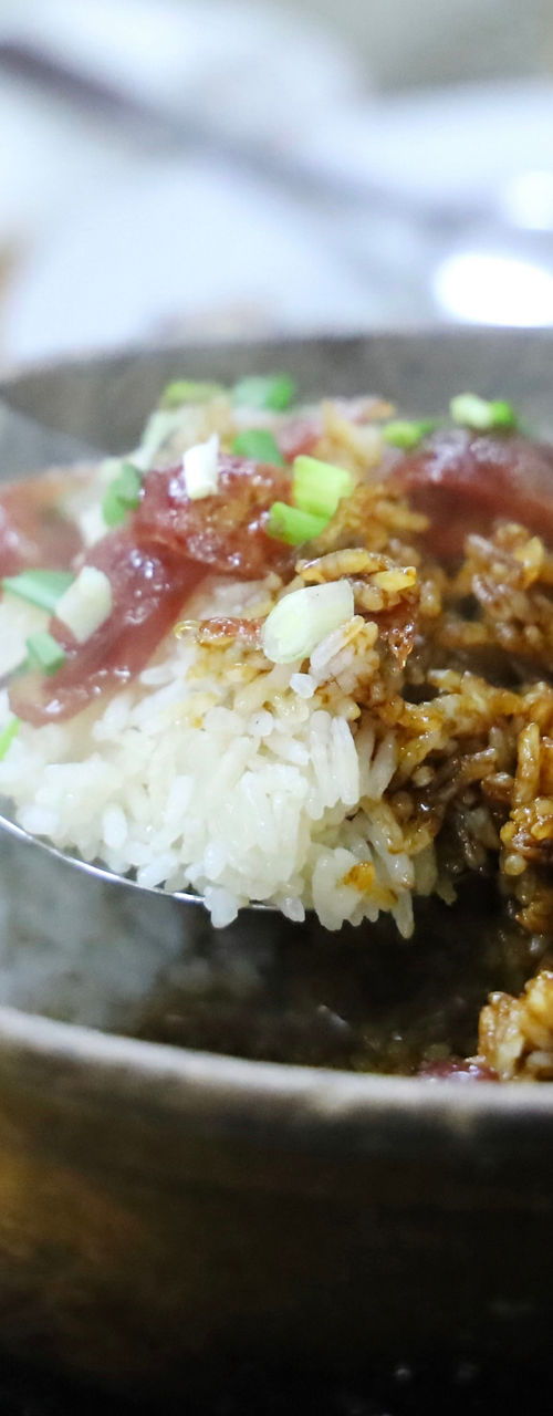 Hand Serving Steaming Claypot Rice Dish