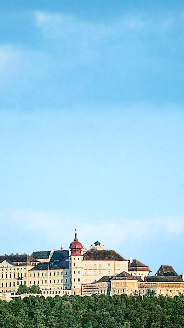 Historic clock tower and distant castle view