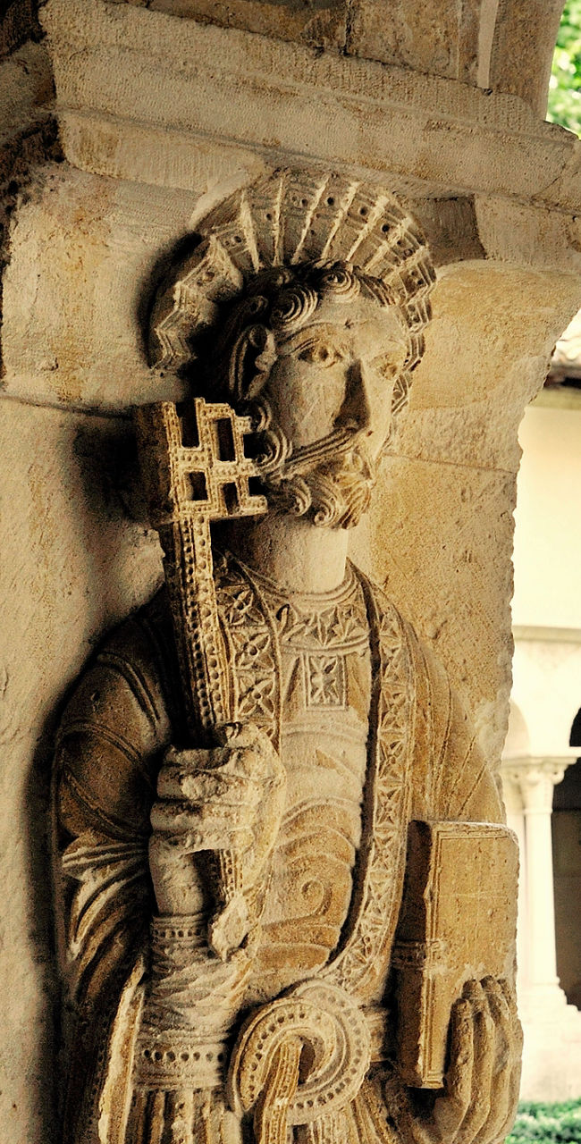 Historic stone statue in cloister garden