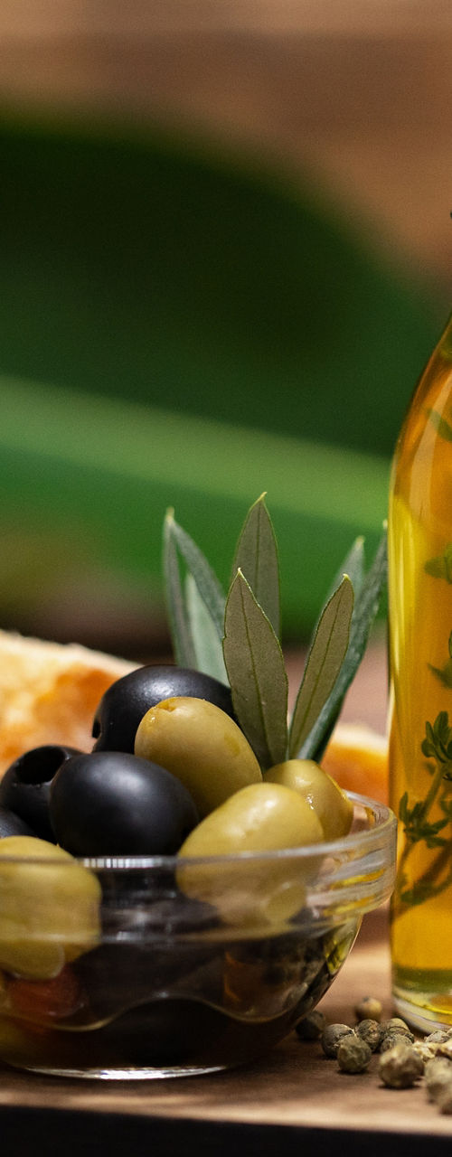 Glass bottle of herb-infused olive oil