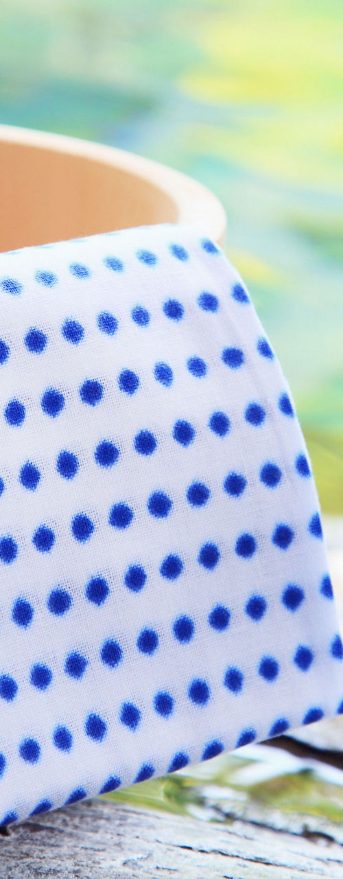 Wooden bucket with polka dot towel outdoors