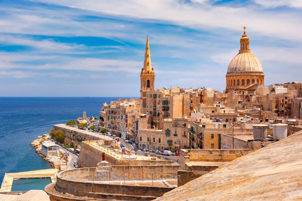 Historic Mediterranean cityscape with domed cathedral and sea