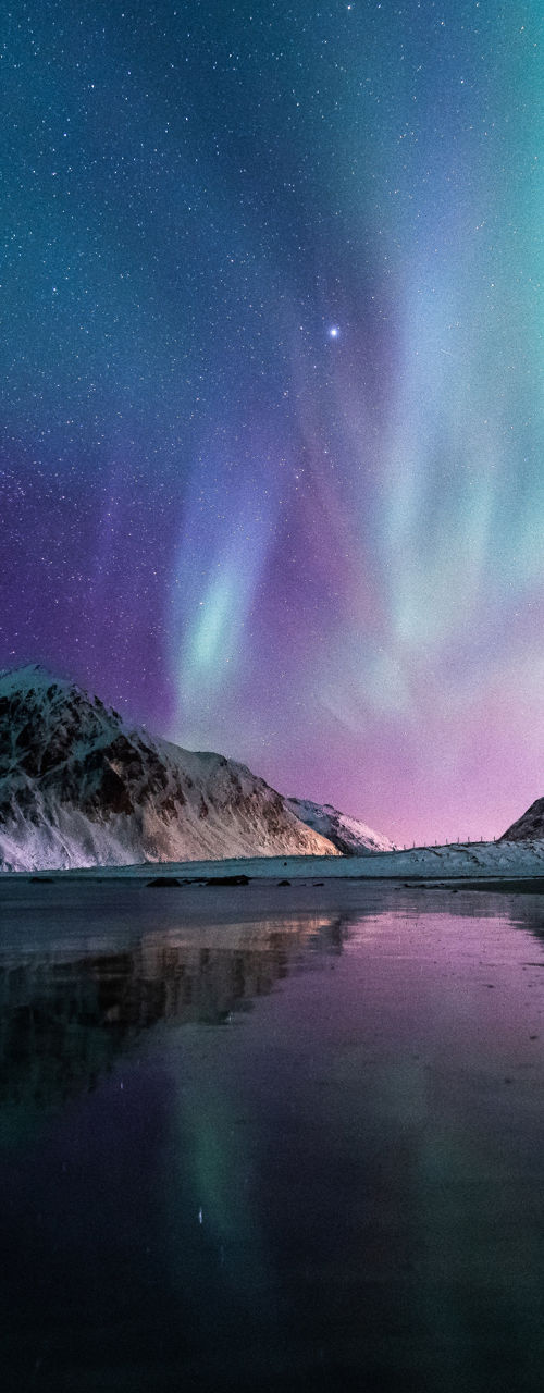 Aurora Borealis over Snowy Mountain Landscape