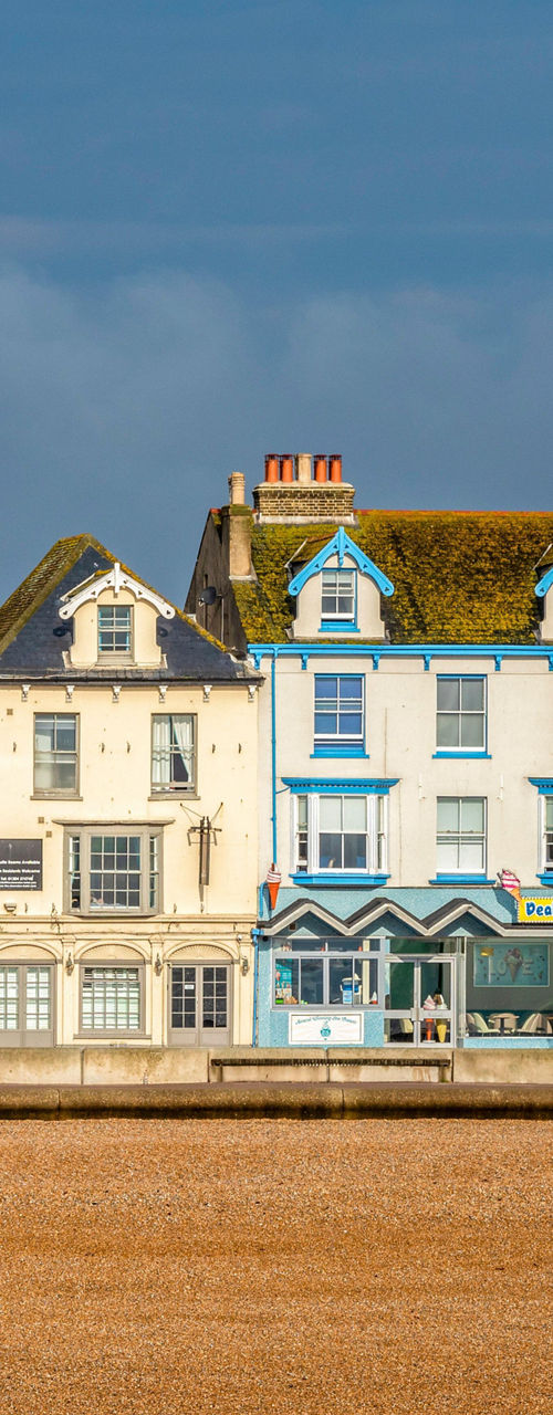Colorful seaside houses along pebble beach