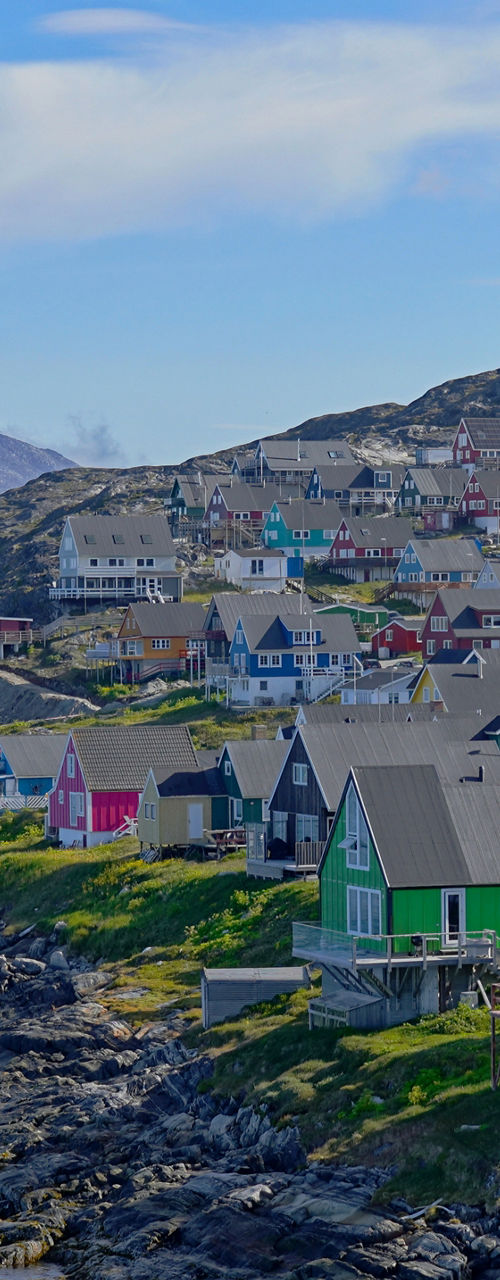 Colorful coastal village with mountain backdrop