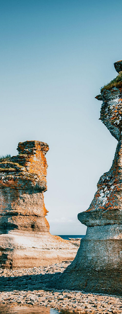 Rock formations by calm coastal waters