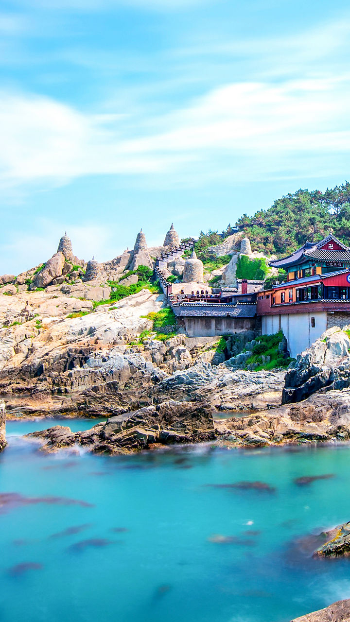 Scenic coastal temple with rocky shoreline