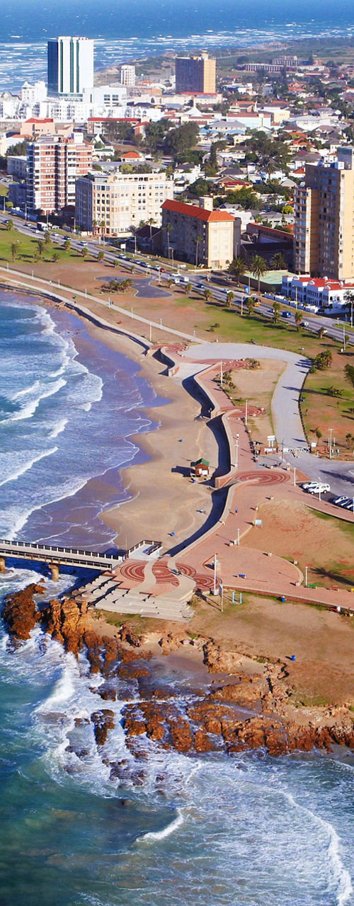 Coastal cityscape with ocean pier and skyline