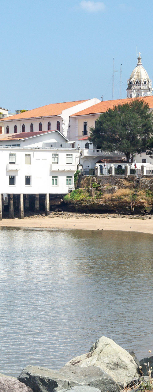 Historic waterfront buildings with sandy beach