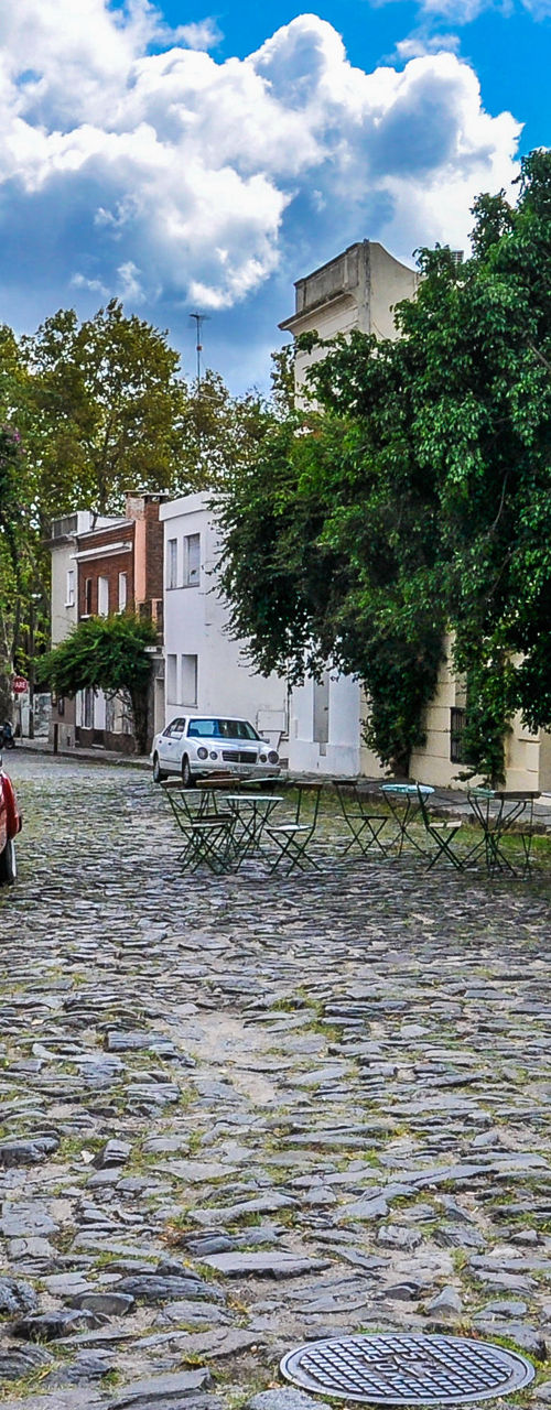Cobblestone street with vintage red car