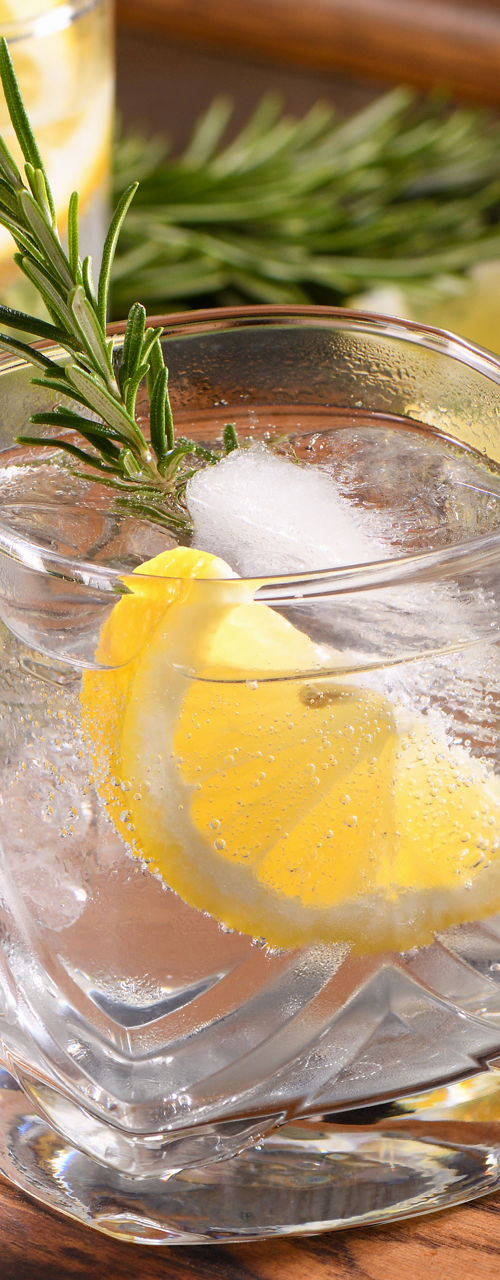 Refreshing lemon rosemary cocktails on wooden tray