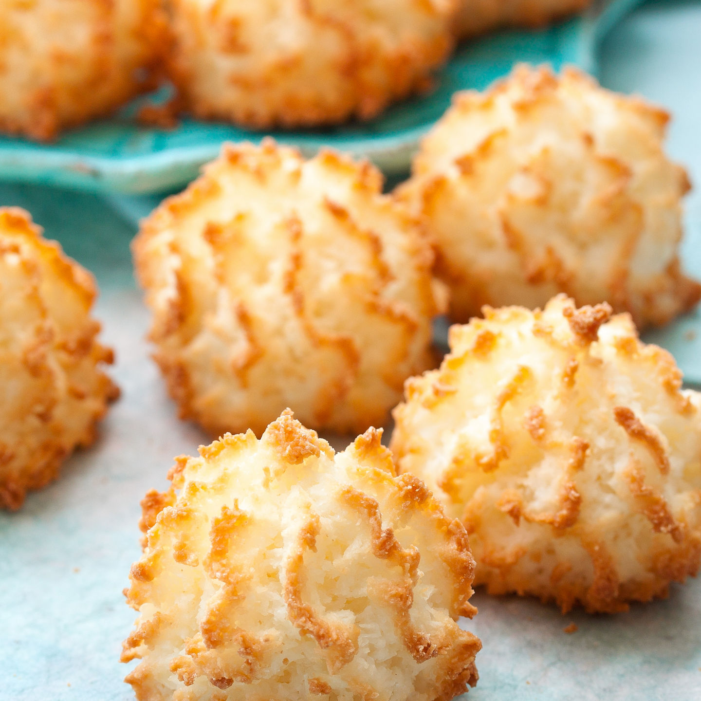 Golden coconut macaroons on blue napkin