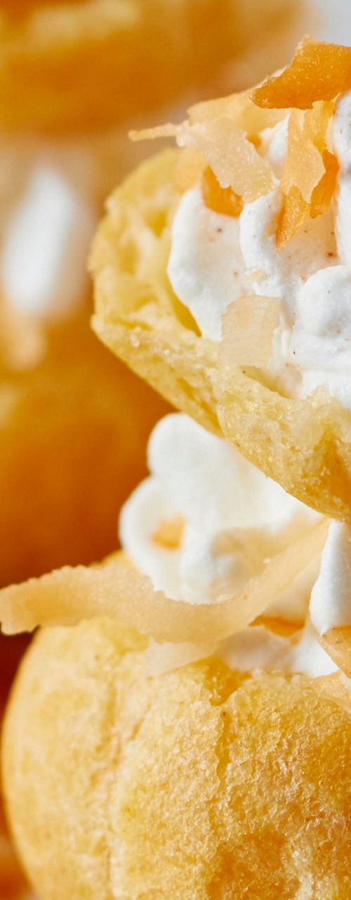 Cream-filled pastries with tropical garnish