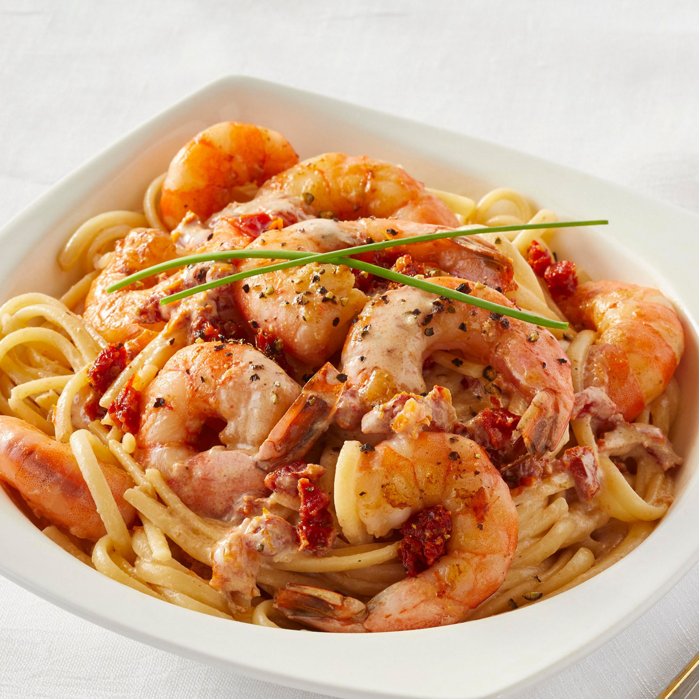 Shrimp pasta in creamy sauce with garnish