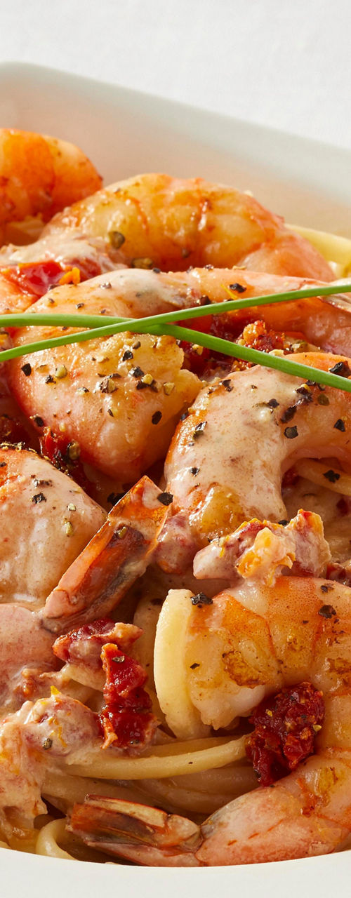 Shrimp pasta in creamy sauce with garnish