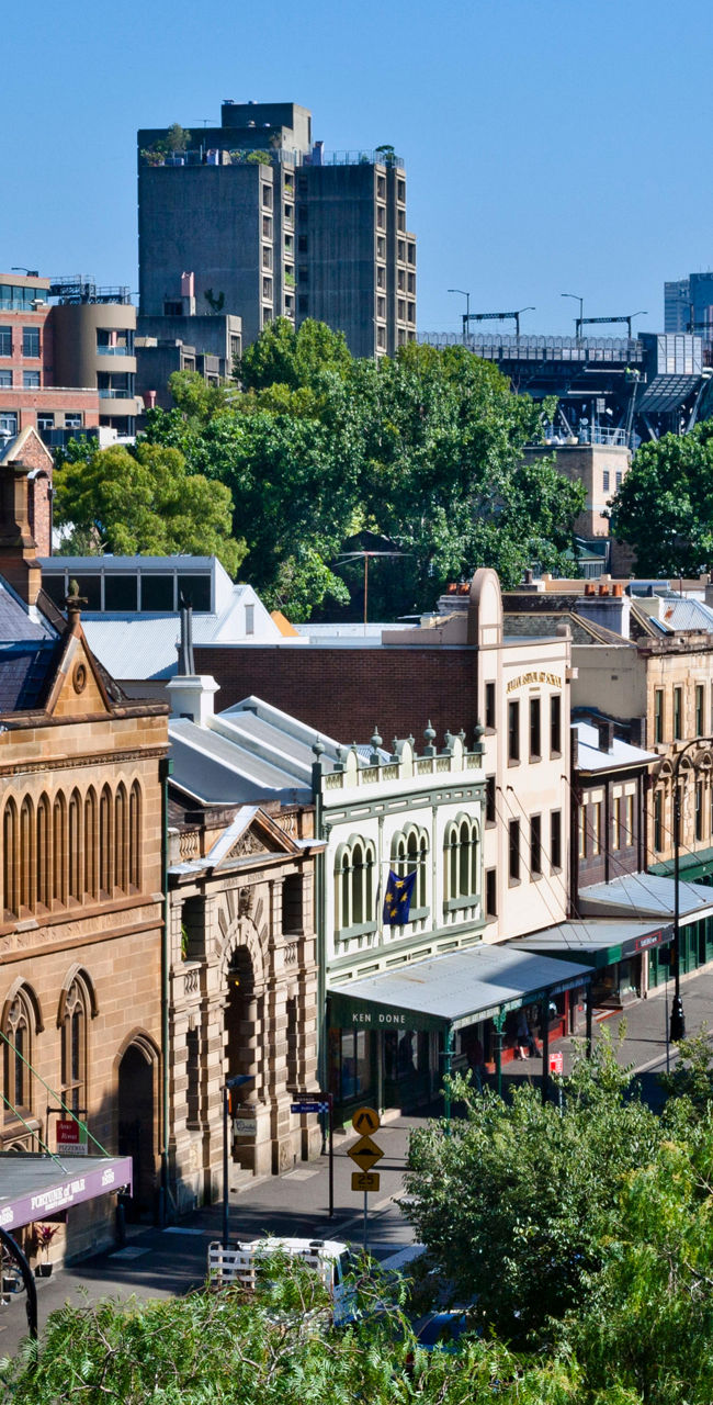 Historic Sydney street with urban skyline